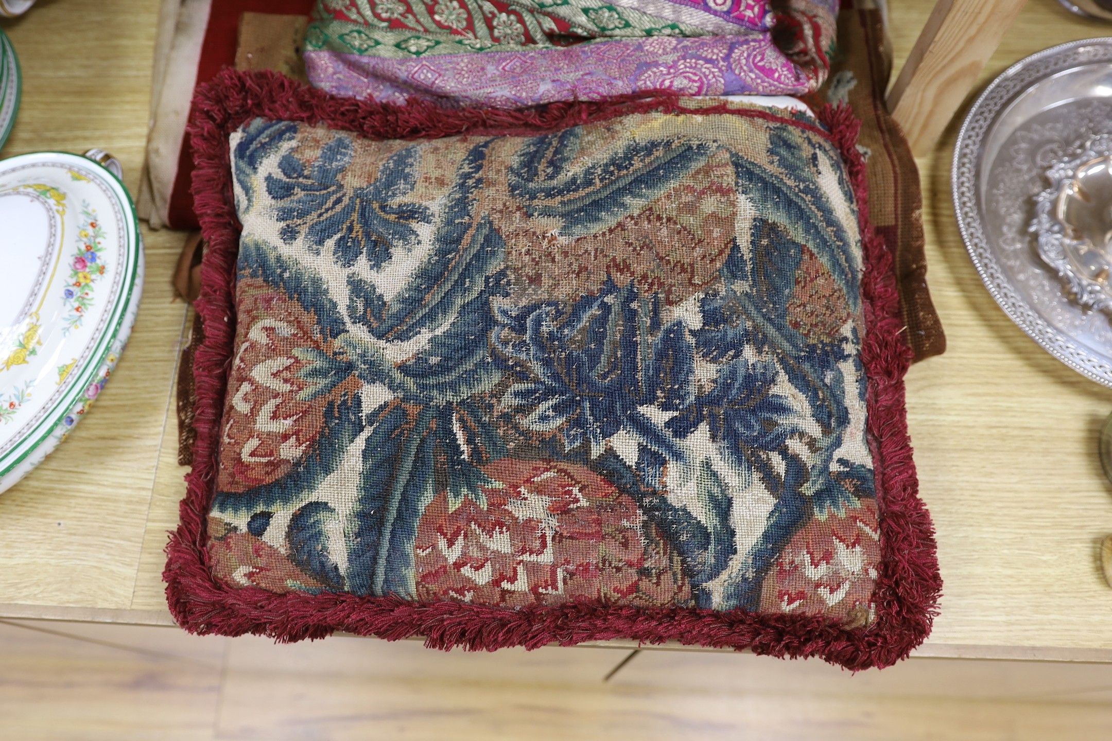 A French 18th century woolwork cushion, 2 chair covers, another panel, a tasselled brocade cushion and an Indian metallic brocaded patchworked cover